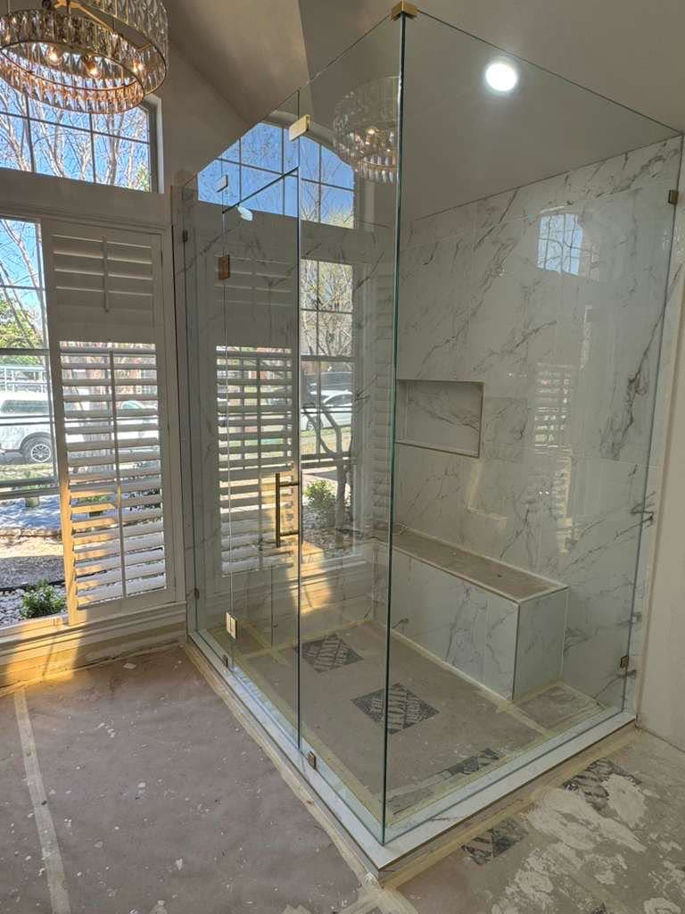 Bright, airy remodeled bathroom with frameless glass shower in McKinney, TX
