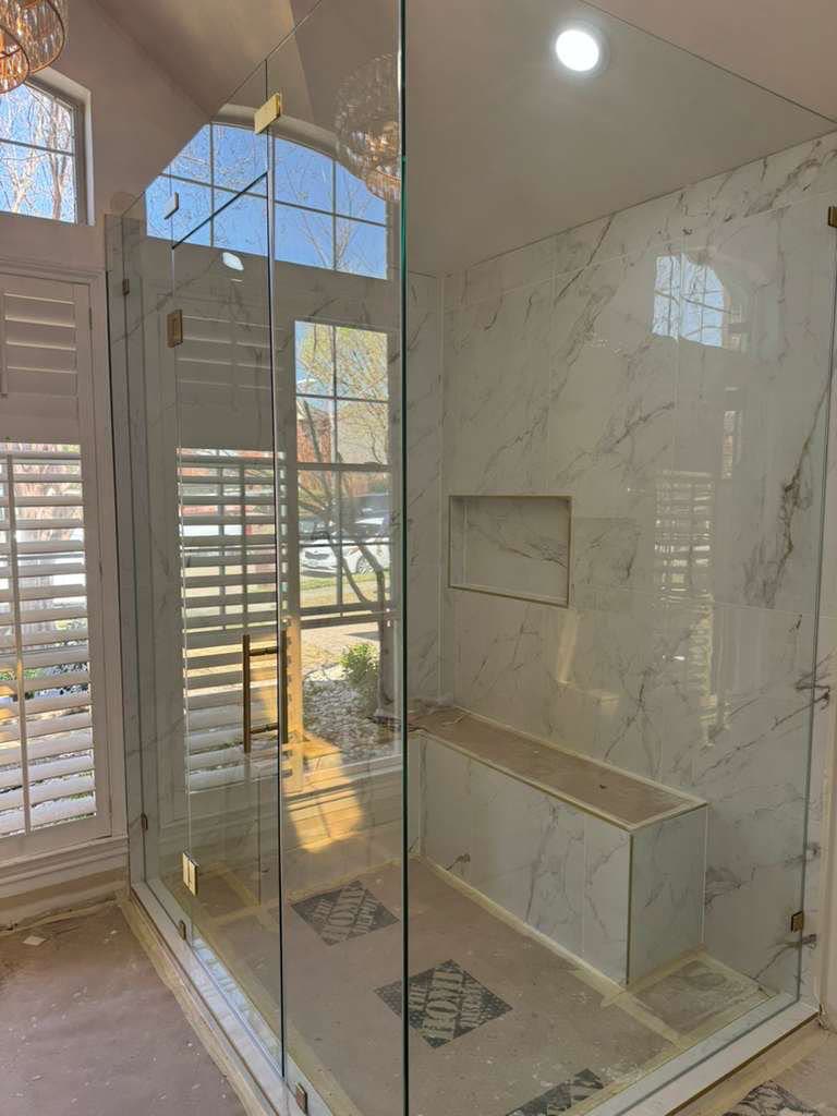 Spa-style walk-in shower with plantation shutters in Southlake, TX