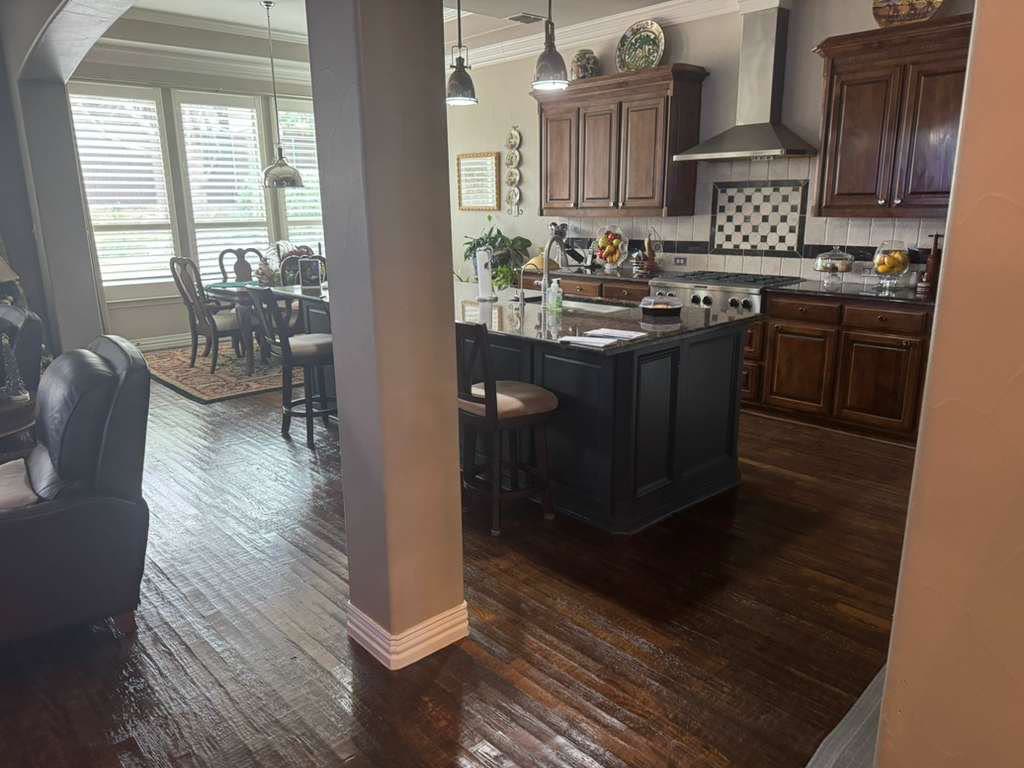 Open-concept remodeled kitchen with custom island and hardwood floors